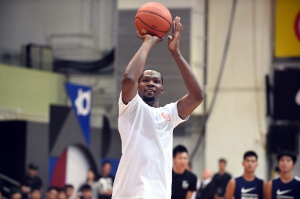 NBA star Kevin Durant shows his basketball skills at a promotional event for Nike Rise Academy during his Asia tour in Hong Kong, China, 12 July 2016.